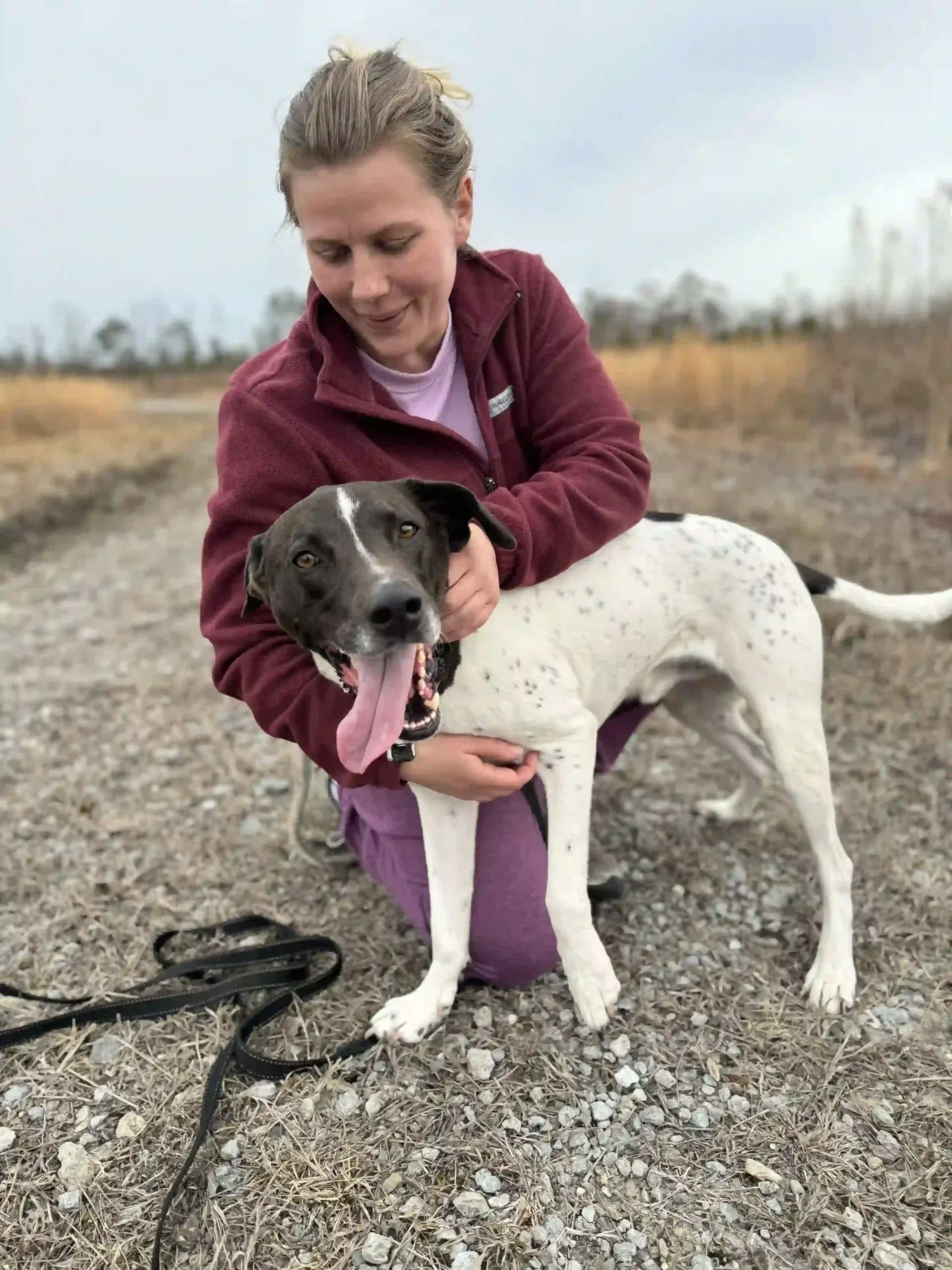 trainer and a dog, playing and training his behaviors without the leash
